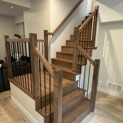 Custom hardwood staircase with black metal spindles